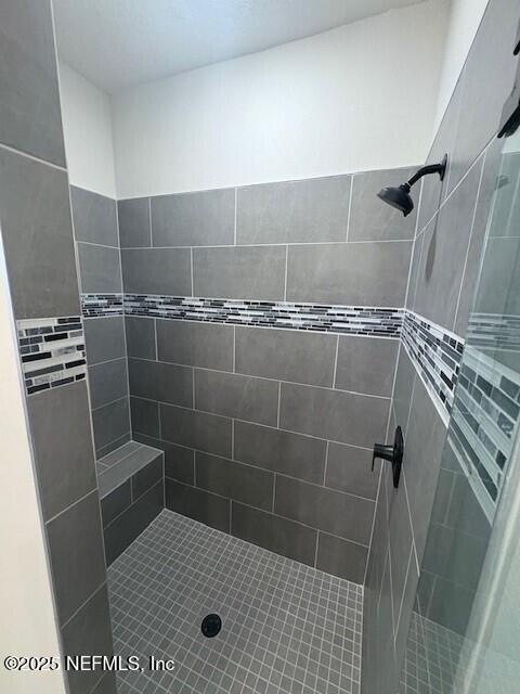 bathroom with a tile shower