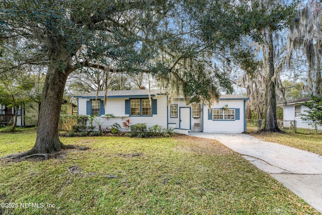 single story home featuring concrete driveway, fence, and a front lawn