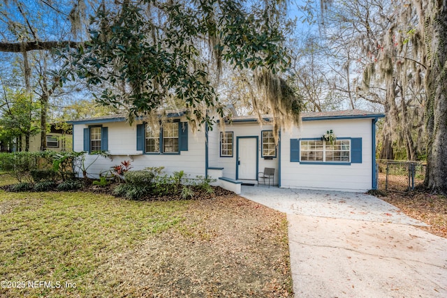 single story home with driveway, a front lawn, and fence