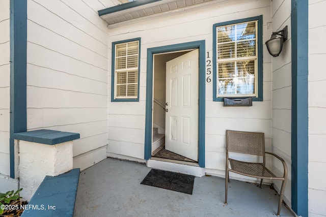 view of exterior entry featuring concrete block siding