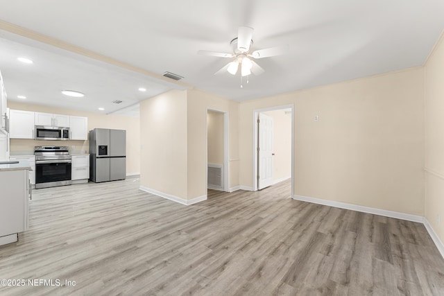 kitchen with light wood-style floors, visible vents, stainless steel appliances, and light countertops