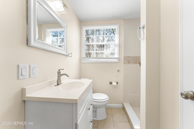 bathroom with toilet, vanity, tile patterned flooring, baseboards, and walk in shower