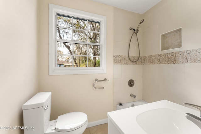 bathroom with shower / bath combination, a sink, and toilet