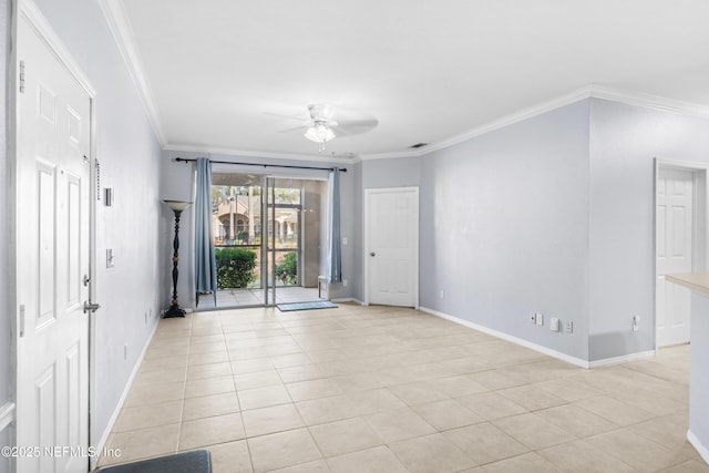 spare room featuring light tile patterned floors, baseboards, crown molding, and a ceiling fan
