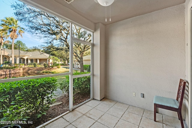unfurnished sunroom with a residential view