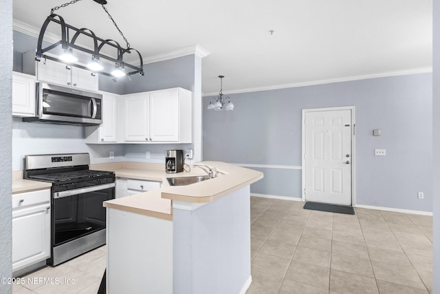 kitchen featuring a peninsula, a sink, ornamental molding, stainless steel appliances, and white cabinets