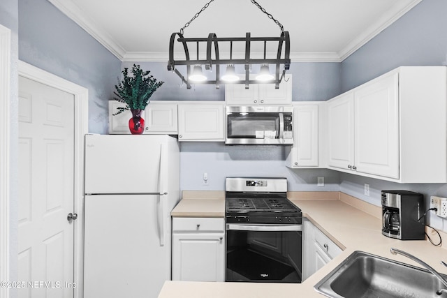 kitchen featuring crown molding, light countertops, white cabinets, stainless steel appliances, and a sink