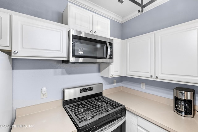 kitchen featuring white cabinetry, light countertops, crown molding, and stainless steel appliances