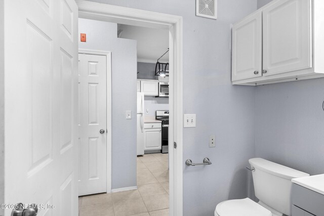 bathroom with visible vents, crown molding, toilet, tile patterned floors, and vanity