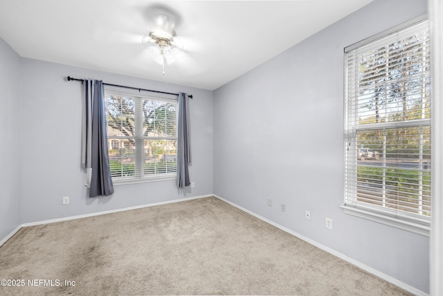 unfurnished room with baseboards, ceiling fan, and carpet flooring