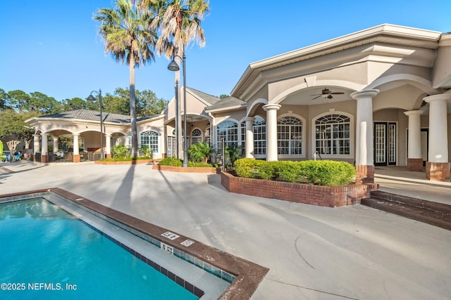 pool featuring a ceiling fan and a patio area