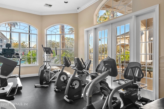 gym featuring visible vents, baseboards, and crown molding