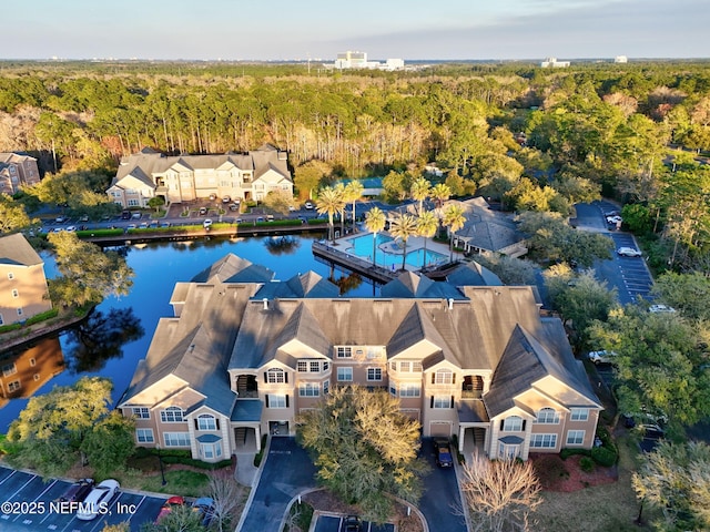 drone / aerial view featuring a water view and a view of trees
