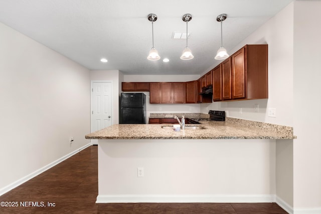 kitchen with visible vents, light stone countertops, a peninsula, black appliances, and a sink