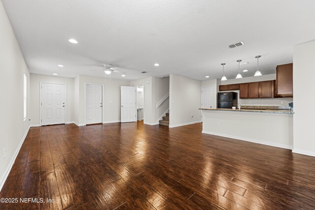 unfurnished living room featuring visible vents, recessed lighting, dark wood-type flooring, and baseboards