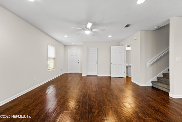 unfurnished living room with hardwood / wood-style floors, stairway, recessed lighting, and baseboards