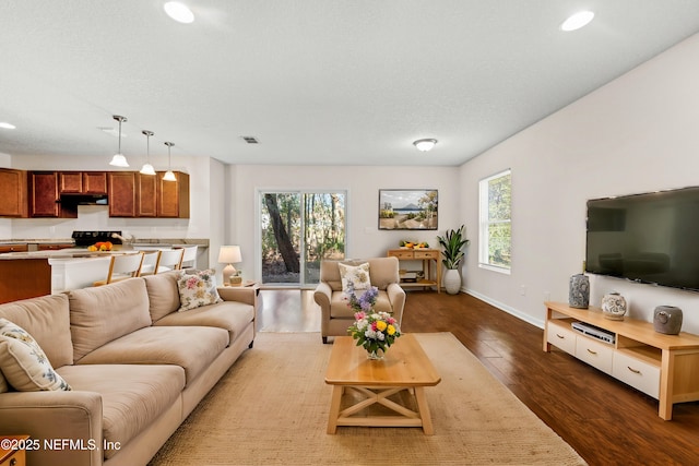 living room featuring recessed lighting, visible vents, baseboards, and dark wood-style flooring