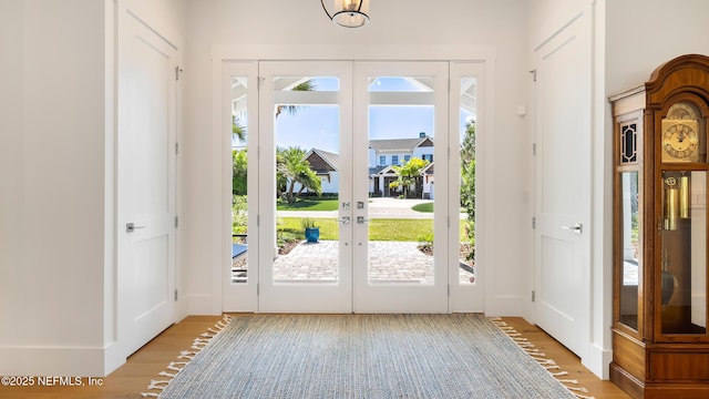 entryway featuring light wood finished floors and french doors