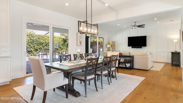 dining room featuring recessed lighting, light wood finished floors, a ceiling fan, and a decorative wall