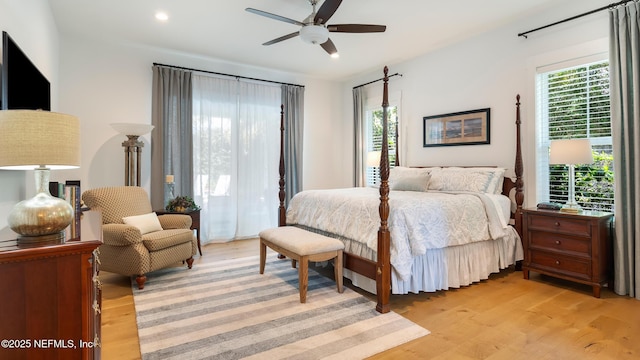 bedroom with multiple windows, light wood-style floors, and recessed lighting