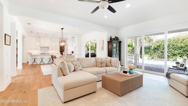 living area featuring recessed lighting, light wood-type flooring, and ceiling fan