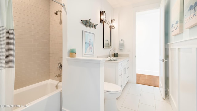 bathroom featuring vanity, baseboards, shower / bath combo, tile patterned floors, and toilet