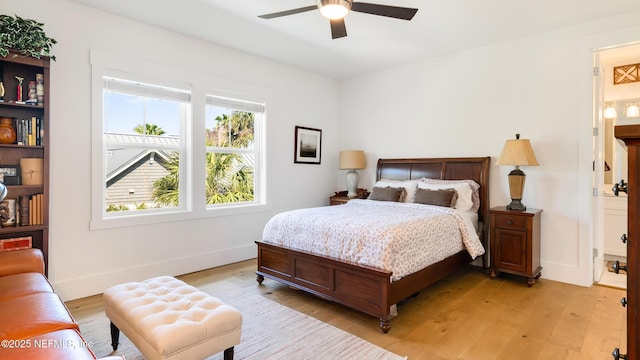 bedroom with baseboards, a ceiling fan, and light wood finished floors