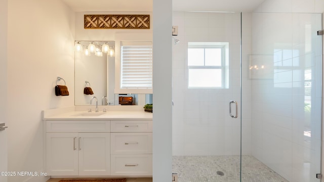 bathroom featuring vanity and a shower stall