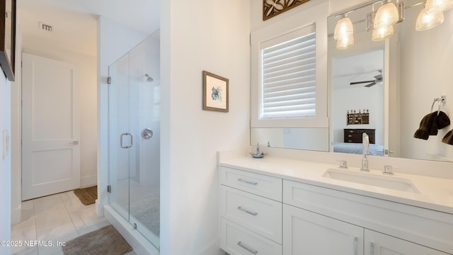 bathroom featuring visible vents, a shower stall, vanity, and a ceiling fan