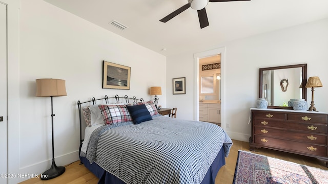 bedroom featuring light wood finished floors, visible vents, connected bathroom, baseboards, and a ceiling fan