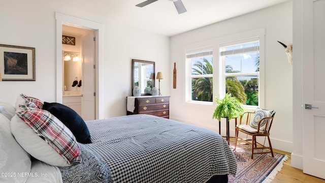 bedroom featuring ceiling fan, wood finished floors, and connected bathroom