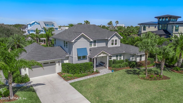 view of front facade featuring a front lawn, a residential view, a garage, and driveway