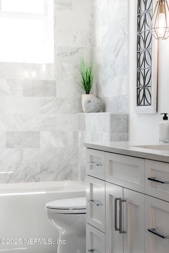 bathroom featuring toilet and vanity