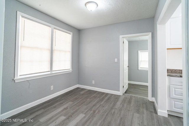 8027 Floyd St, Jacksonville, FL 32208 - unfurnished room featuring a textured ceiling, wood finished floors, and baseboards