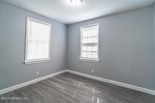 8027 Floyd St, Jacksonville, FL 32208 - empty room with wood finished floors and baseboards