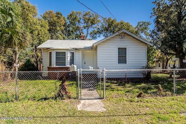 view of front of house with a fenced front yard, a gate, a chimney, and a front yard