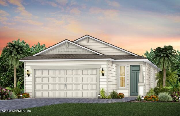 view of front of home with a garage, a shingled roof, decorative driveway, and a front yard