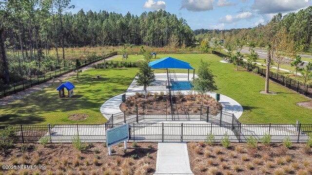 view of property's community featuring fence, a gazebo, and a lawn