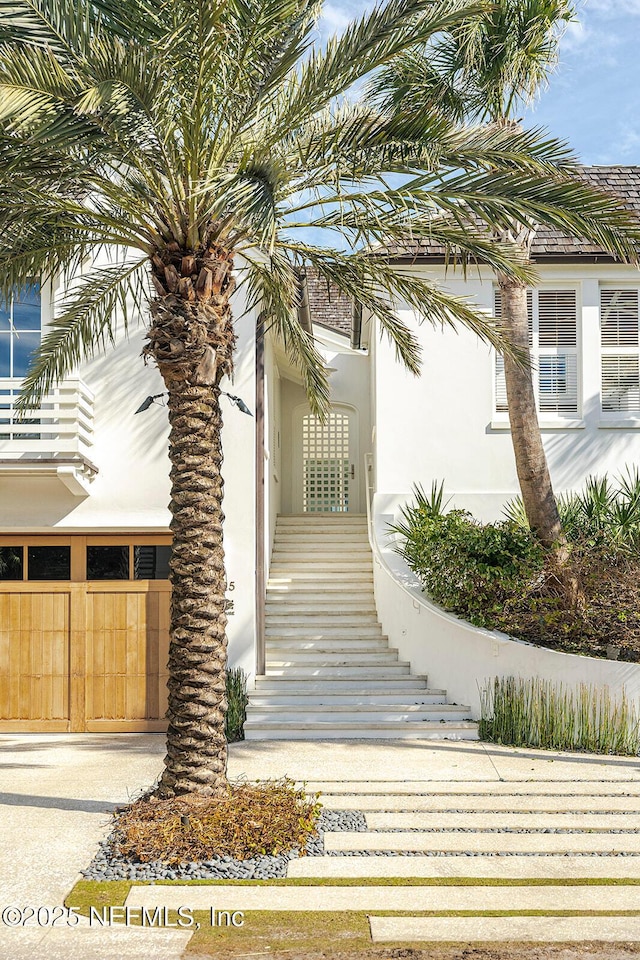 entrance to property featuring stucco siding