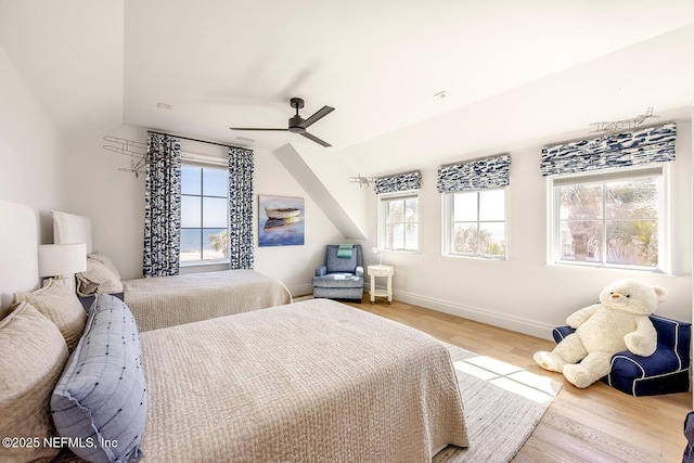 bedroom with ceiling fan, baseboards, and wood finished floors