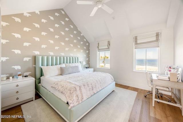 bedroom featuring lofted ceiling, ceiling fan, wood finished floors, and baseboards