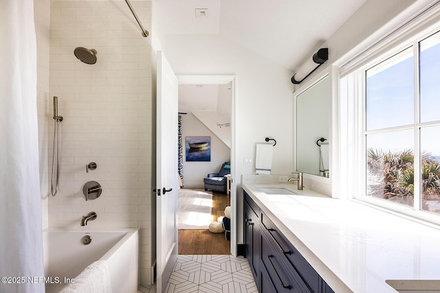 full bathroom with shower / bath combo with shower curtain, vaulted ceiling, and vanity