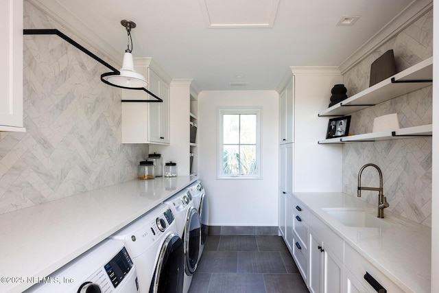 laundry area featuring laundry area, separate washer and dryer, and a sink