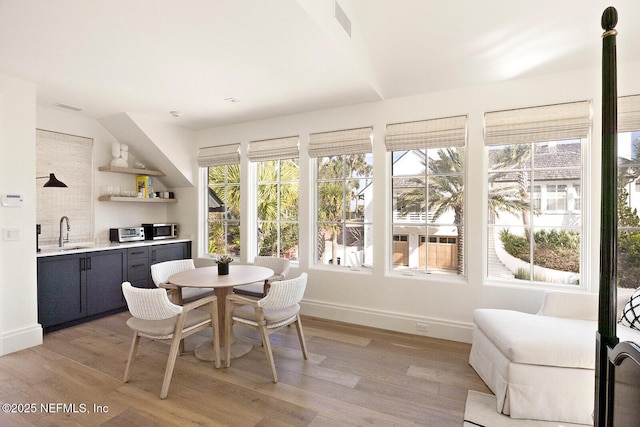 sunroom featuring a sink, visible vents, and a toaster