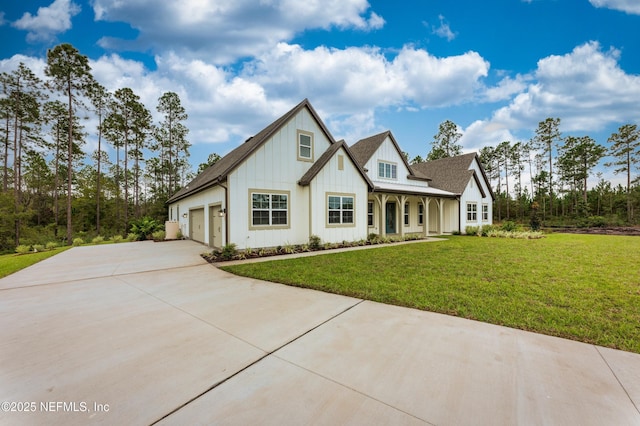 view of front of home featuring concrete driveway, a front lawn, and board and batten siding