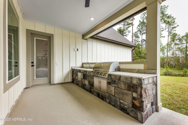 view of patio featuring exterior kitchen, area for grilling, and a sink