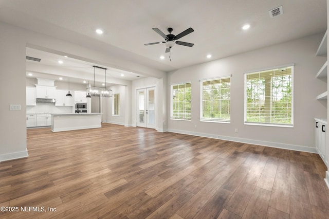 unfurnished living room featuring a ceiling fan, light wood-type flooring, baseboards, and recessed lighting