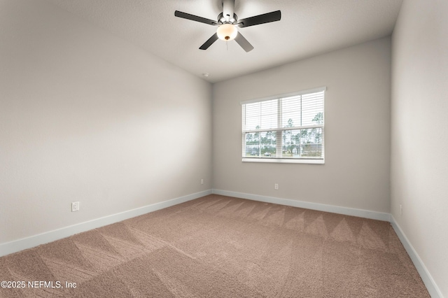 unfurnished room featuring a ceiling fan, light carpet, and baseboards