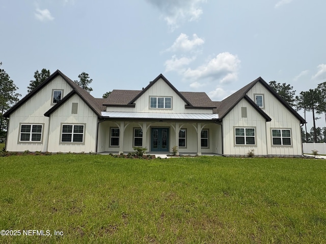 36166 Pitch Ln, Hilliard, FL 32046 - modern farmhouse featuring board and batten siding, a front lawn, french doors, and a porch
