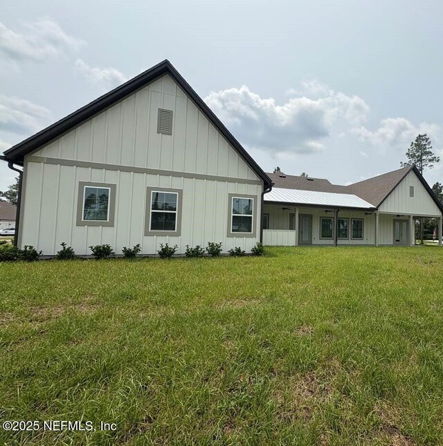 36166 Pitch Ln, Hilliard, FL 32046 - rear view of property featuring board and batten siding and a yard